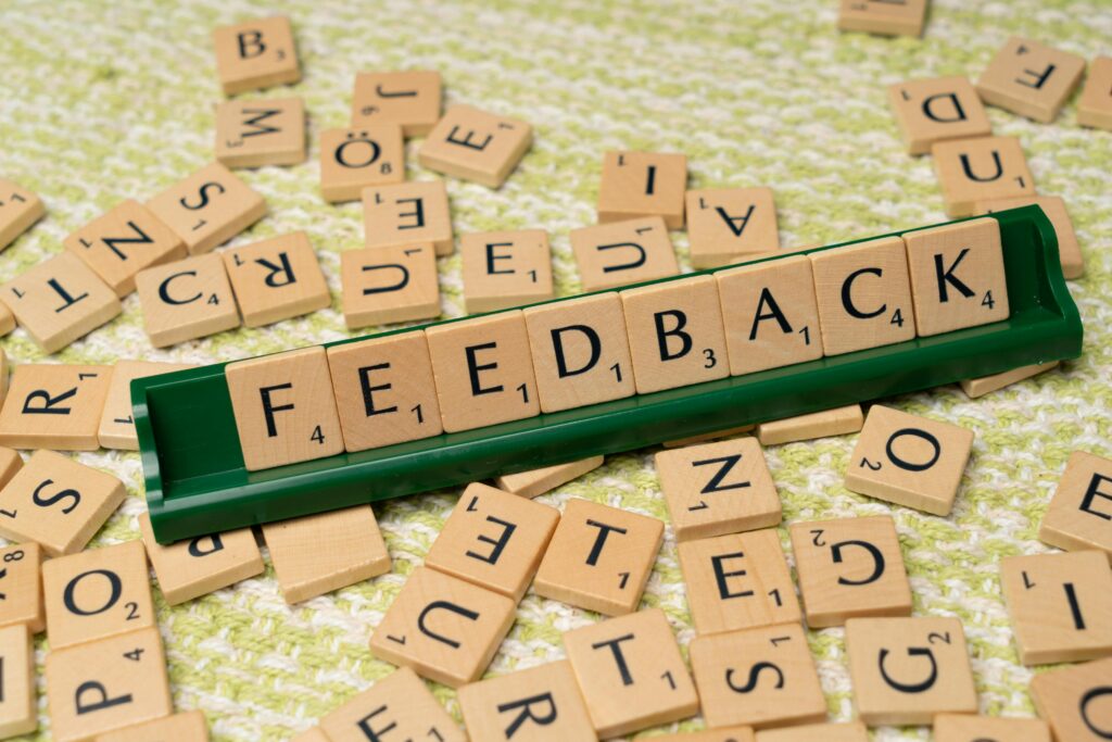 pexels photo 18512803 18512803 Wooden letter tiles spelling 'feedback' on a green rack, representing communication and evaluation.